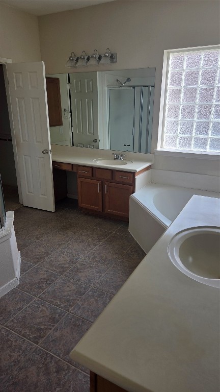 2103 Trinity Manor Lane Richmond, TX 77469 - Photo 26 of 30 a bathroom with a double vanity sink and a bathtub
