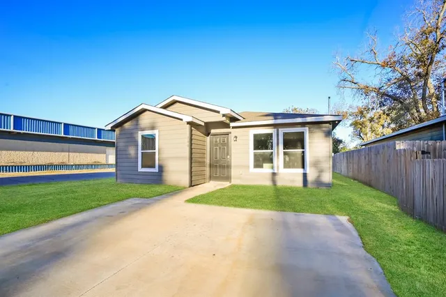 a view of a yard in front of a house with a small yard