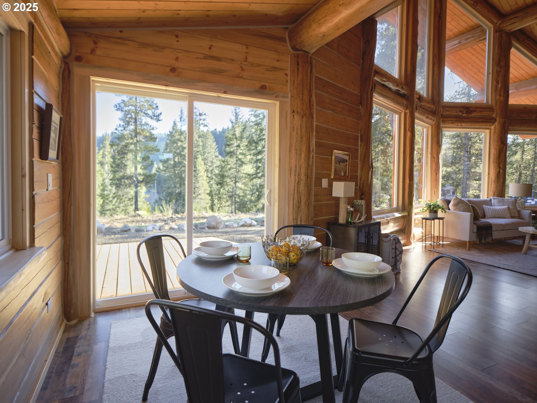 192 Sasquatch Way Cougar, WA 98616 - Photo 11 of 47 a view of a dining room with furniture large windows and wooden floor