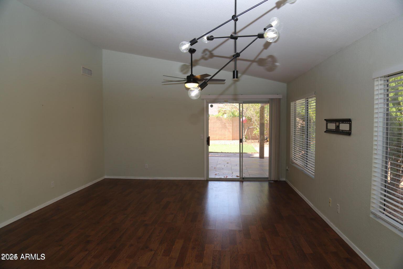 2228 East Aire Libre Avenue Phoenix, AZ 85022 - Photo 11 of 24 a view of a room with wooden floor and windows