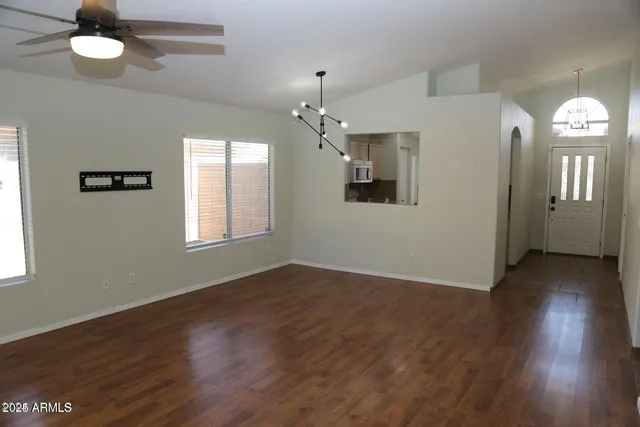 a view of a livingroom with a window and wooden floor
