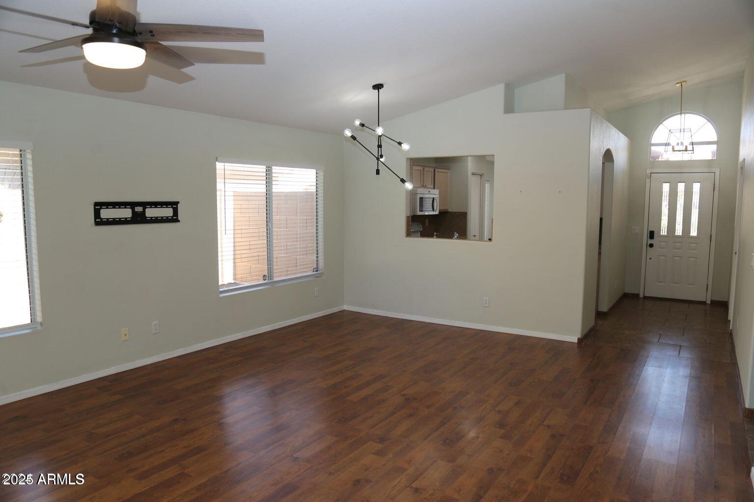 2228 East Aire Libre Avenue Phoenix, AZ 85022 - Photo 12 of 24 a view of a livingroom with a window and wooden floor