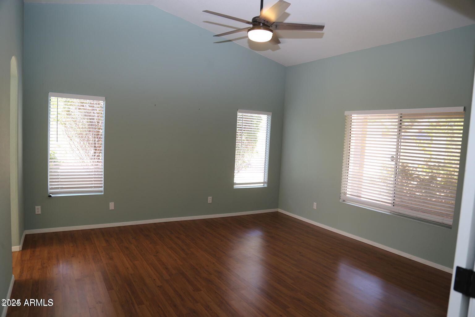 2228 East Aire Libre Avenue Phoenix, AZ 85022 - Photo 17 of 24 a view of an empty room with wooden floor and a window