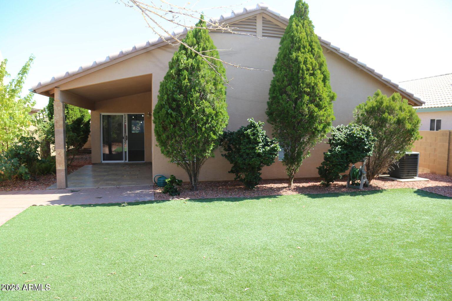 2228 East Aire Libre Avenue Phoenix, AZ 85022 - Photo 20 of 24 front view of a house with a yard and potted plants