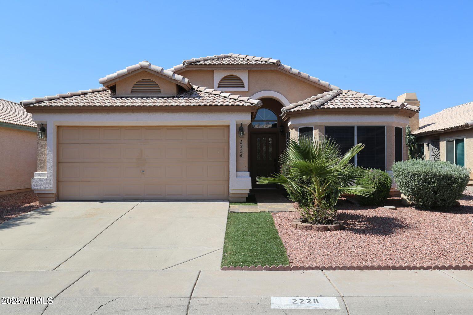 2228 East Aire Libre Avenue Phoenix, AZ 85022 - Photo 2 of 24 a front view of a house with garden