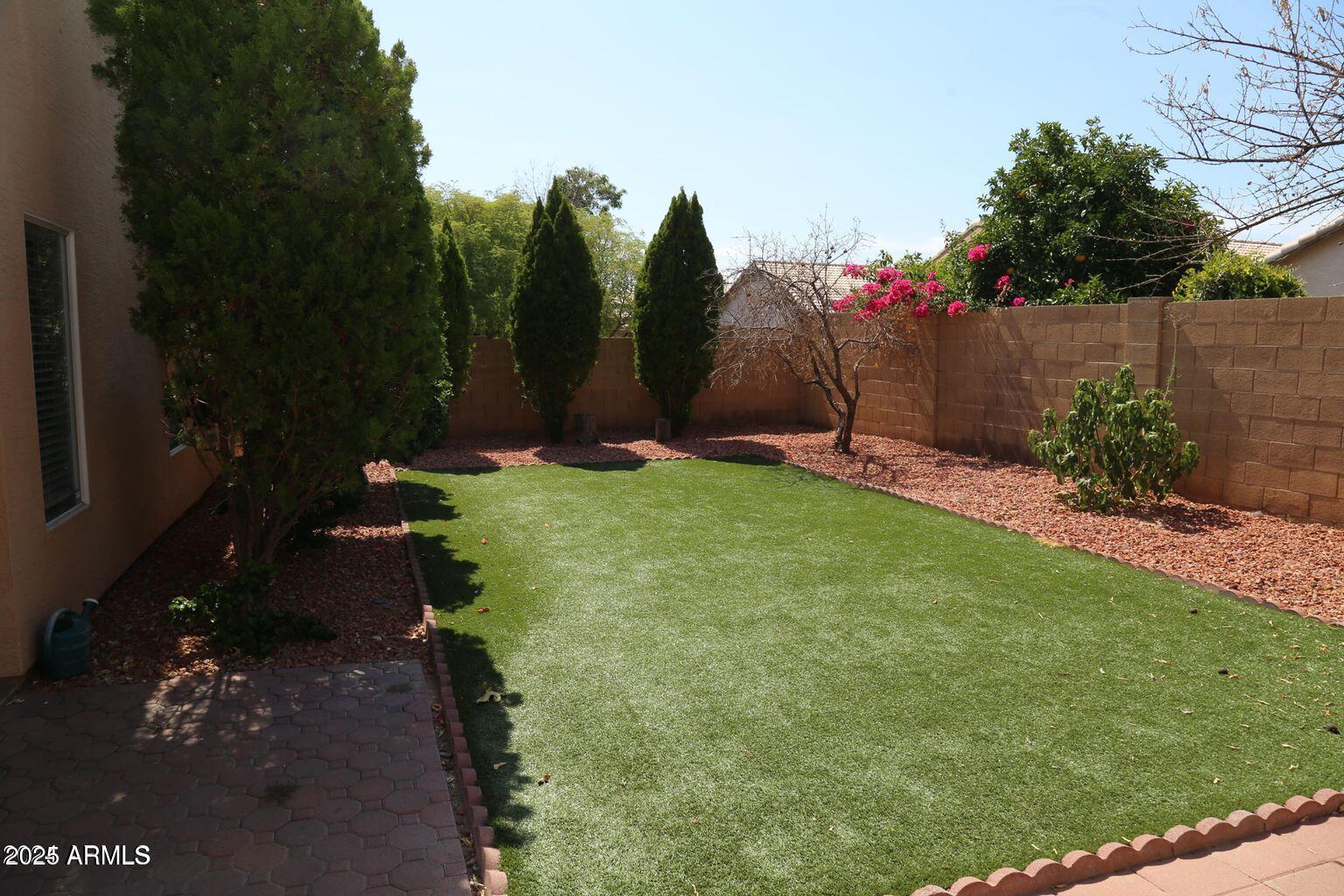 2228 East Aire Libre Avenue Phoenix, AZ 85022 - Photo 22 of 24 a backyard of a house with lots of green space