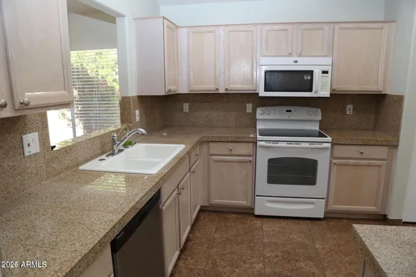 a kitchen with a sink stove and microwave