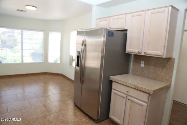 a kitchen with stainless steel appliances granite countertop a refrigerator and a cabinets