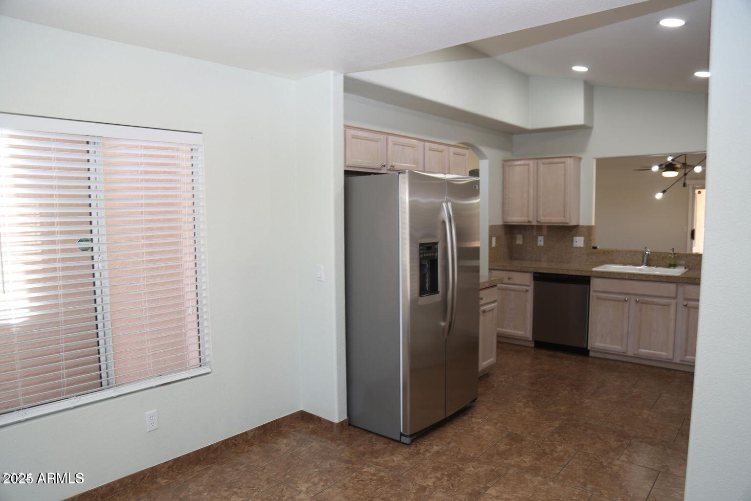 2228 East Aire Libre Avenue Phoenix, AZ 85022 - Photo 8 of 24 a kitchen with a refrigerator and a sink