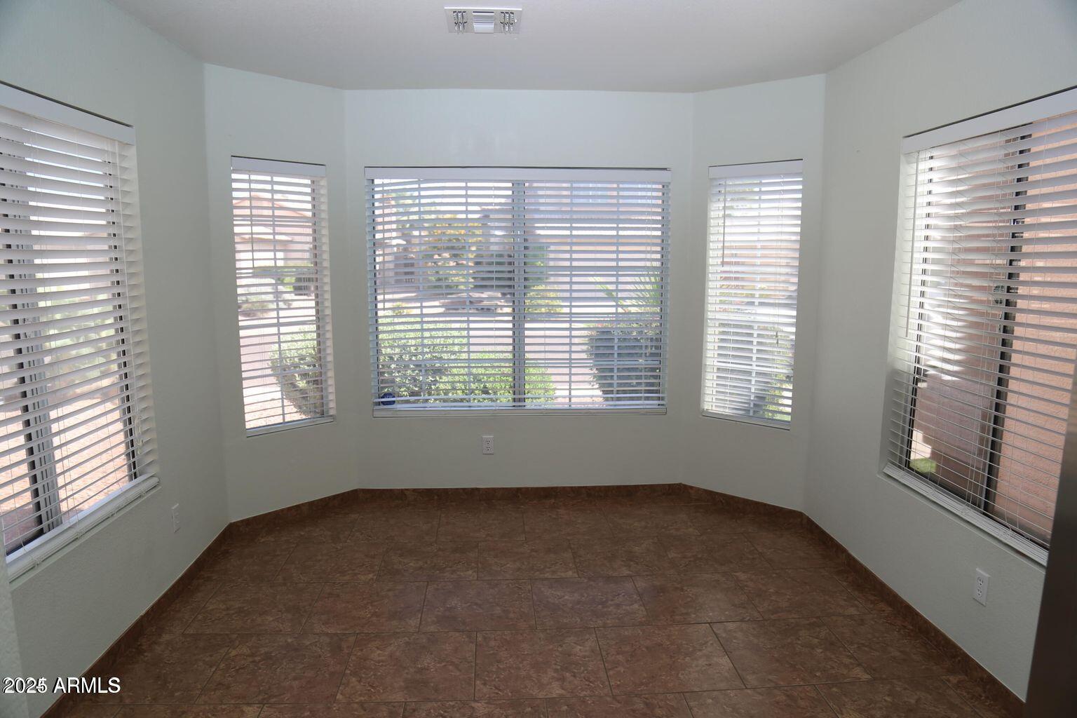 2228 East Aire Libre Avenue Phoenix, AZ 85022 - Photo 9 of 24 an empty room with a window