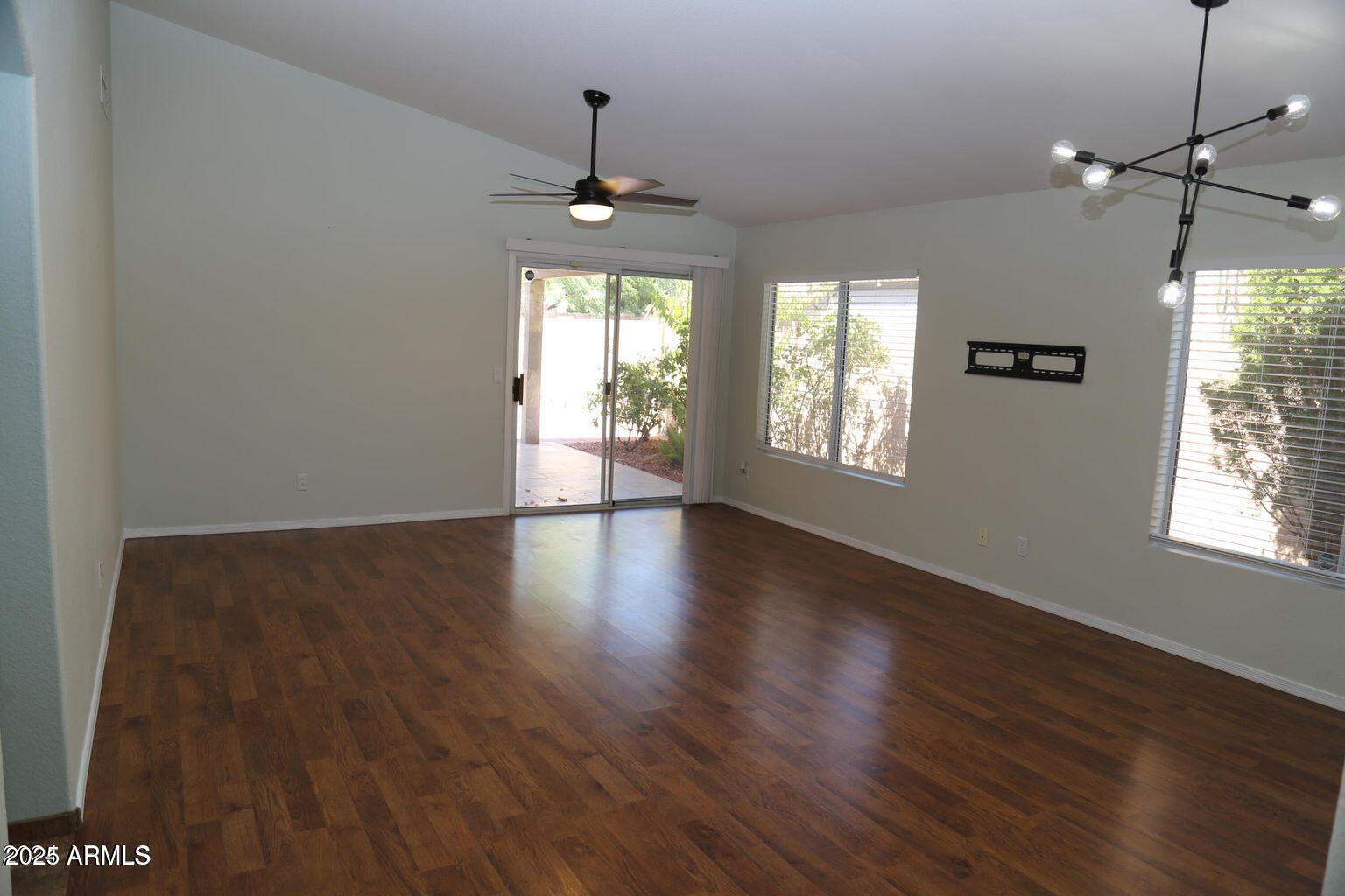 2228 East Aire Libre Avenue Phoenix, AZ 85022 - Photo 10 of 24 a view of an empty room with wooden floor and a window