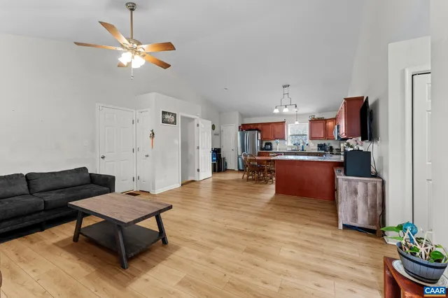 a living room with furniture and a kitchen view