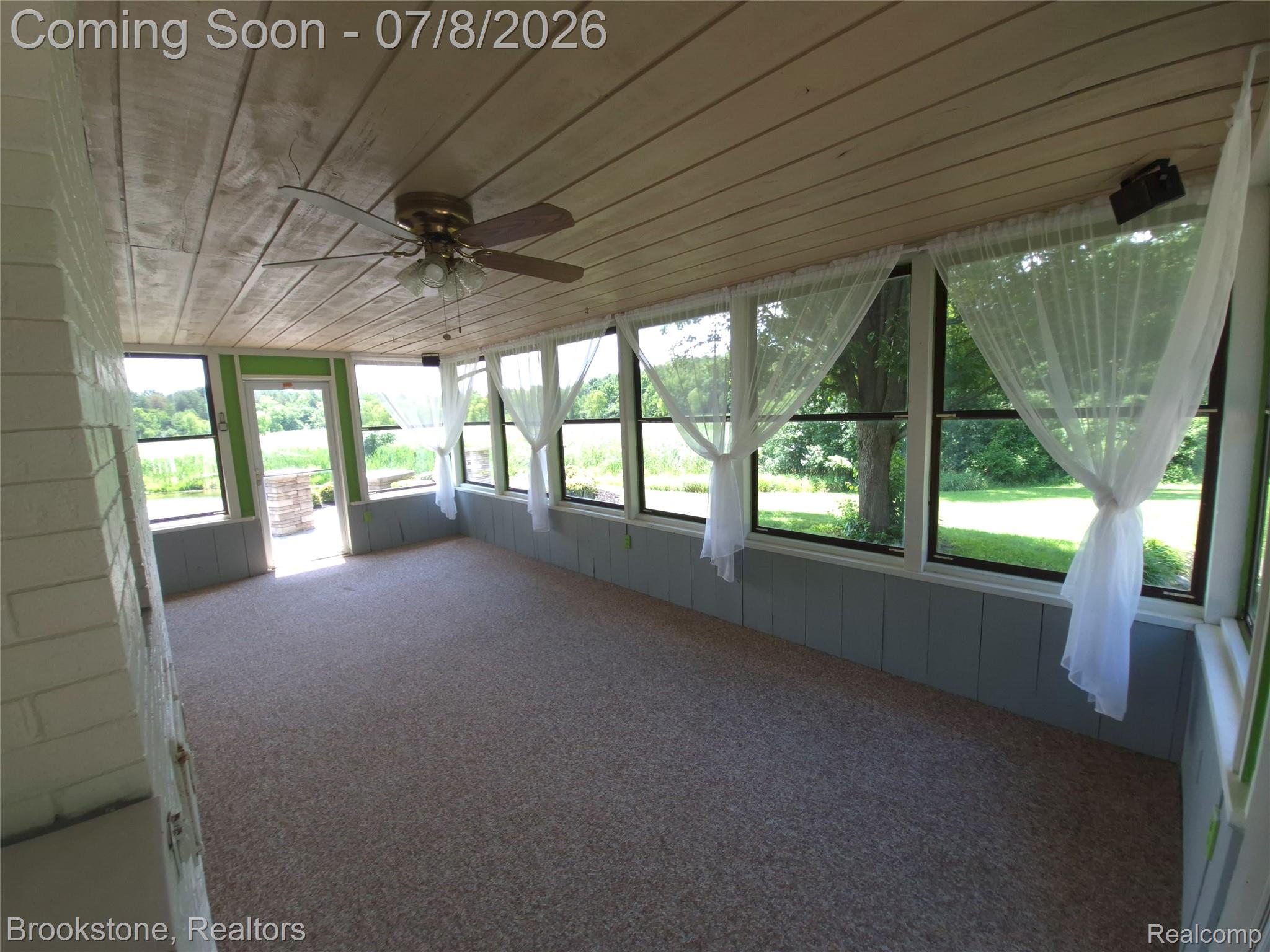 4140 South Henderson Road Davison, MI 48423 - Photo 98 of 98 Spacious enclosed porch featuring a wood-panel ceiling, ceiling fan, and carpet flooring