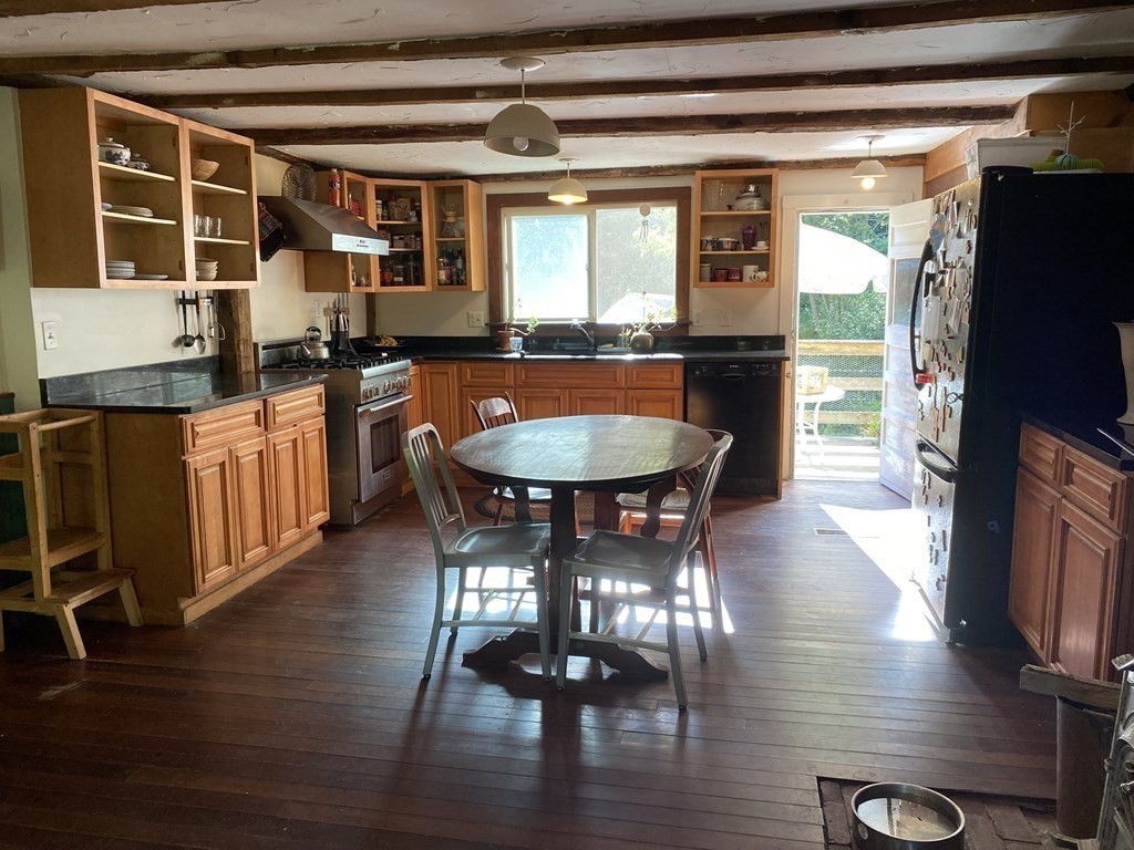 354 Barre Road Petersham, MA 01366 - Photo 4 of 12 a dining room with wooden floor a chandelier a glass table and chairs