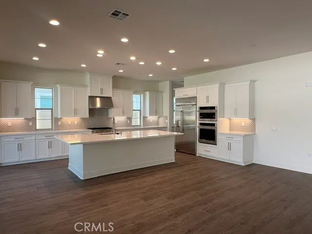 a spacious bathroom with a double vanity sink and a large mirror