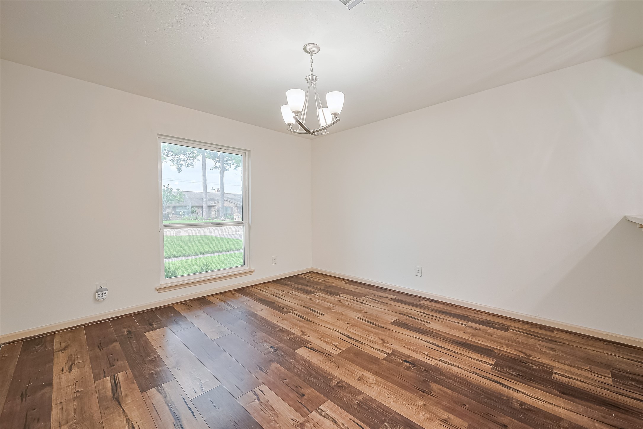 982 West Donovan Street Houston, TX 77091 - Photo 12 of 39 wooden floor in an empty room with a window