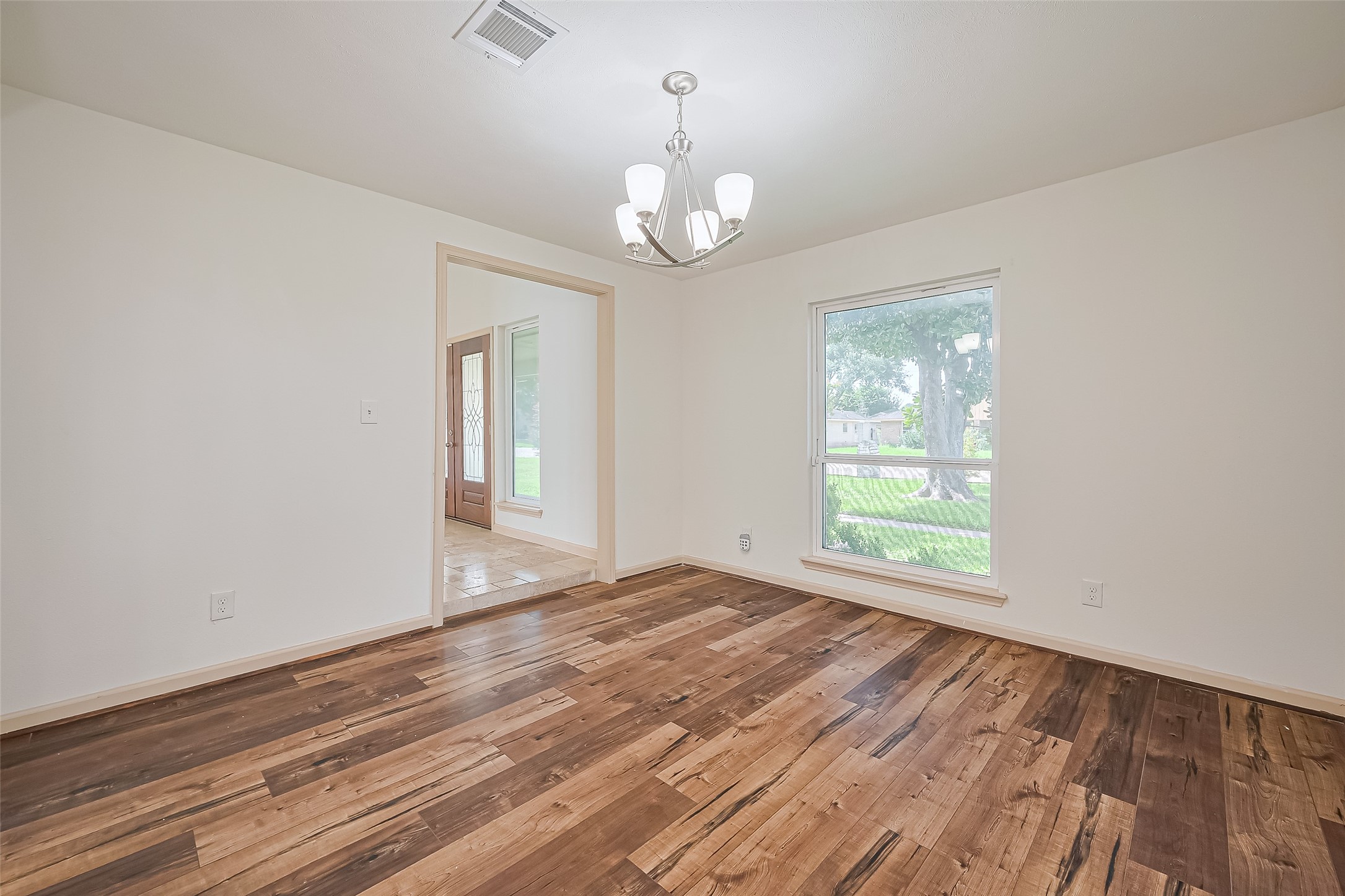 982 West Donovan Street Houston, TX 77091 - Photo 14 of 39 a view of an empty room with wooden floor and a window