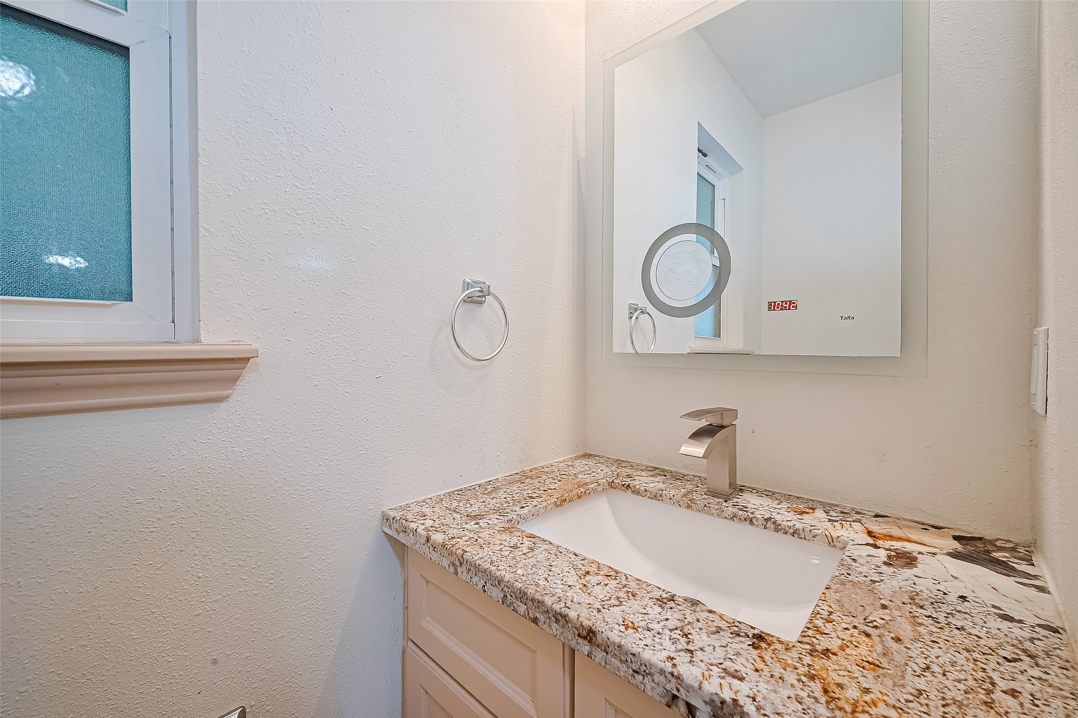982 West Donovan Street Houston, TX 77091 - Photo 16 of 39 a bathroom with a granite countertop sink and a mirror