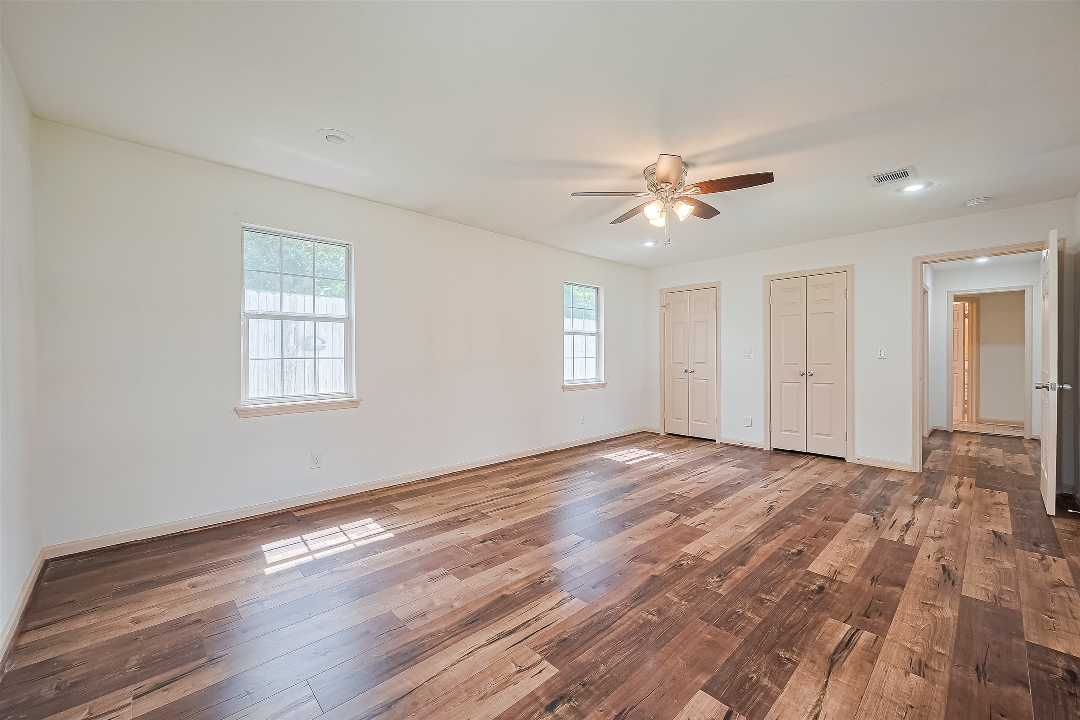 982 West Donovan Street Houston, TX 77091 - Photo 21 of 39 a view of empty room with wooden floor and fan