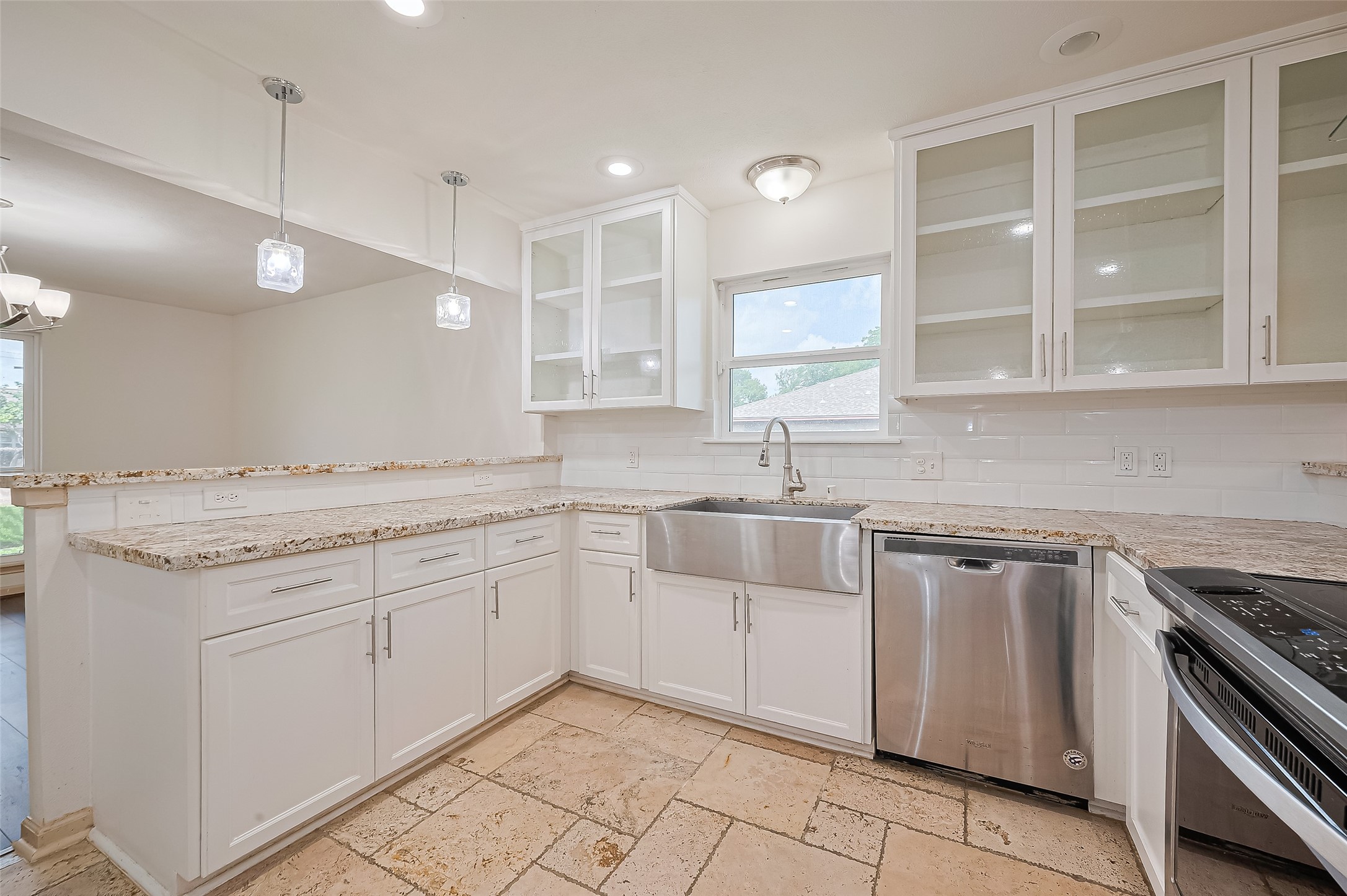 982 West Donovan Street Houston, TX 77091 - Photo 7 of 39 a kitchen with granite countertop white cabinets and white appliances