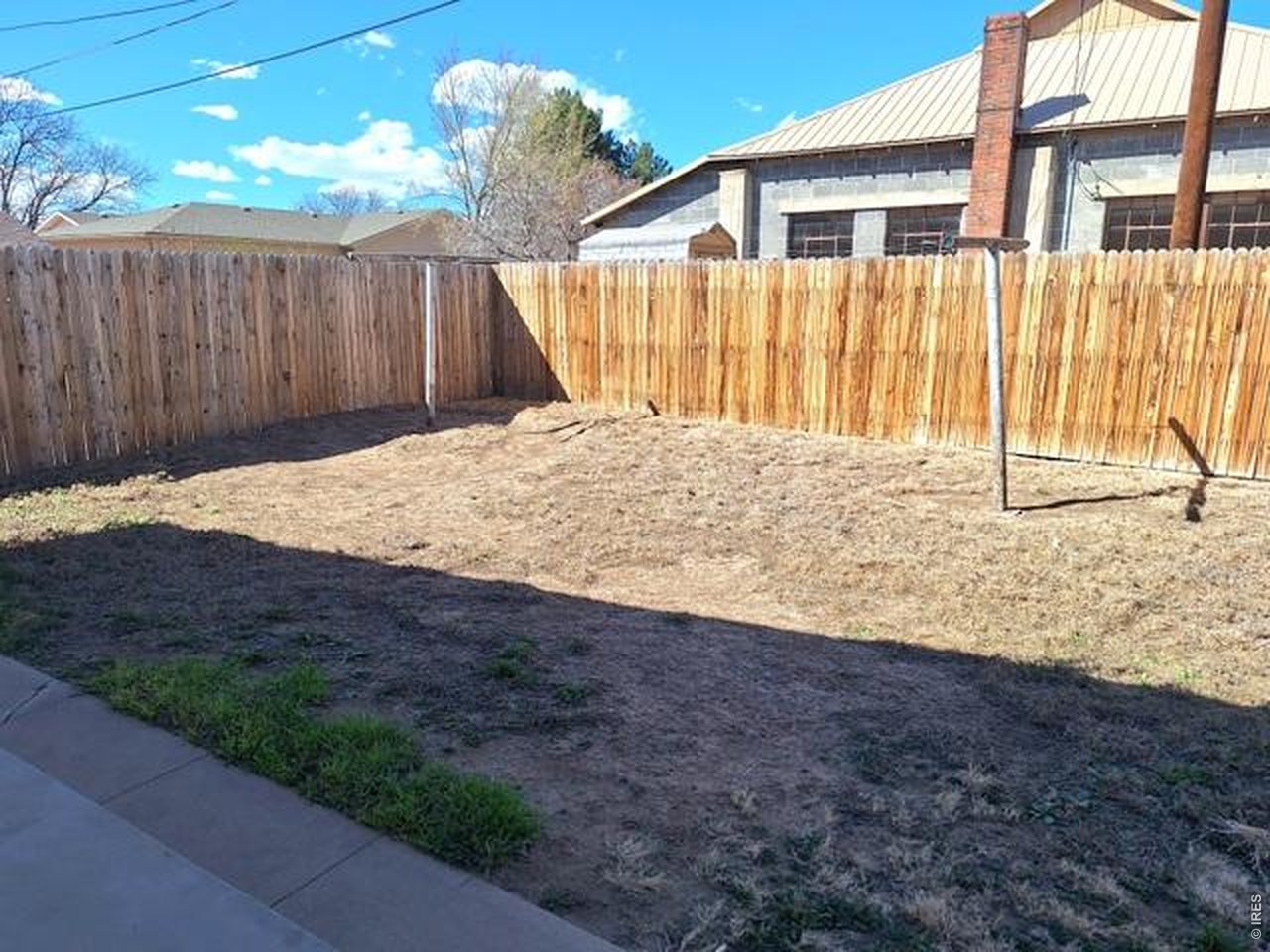 310 Cleveland Street Sterling, CO 80751 - Photo 24 of 25 Back Yard with Clothes Line