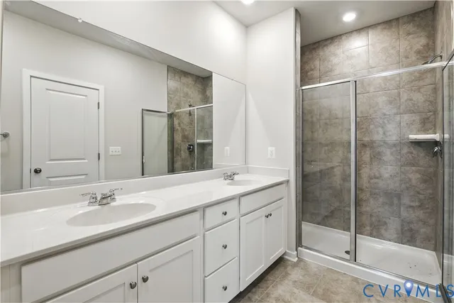 a bathroom with a shower sink and mirror