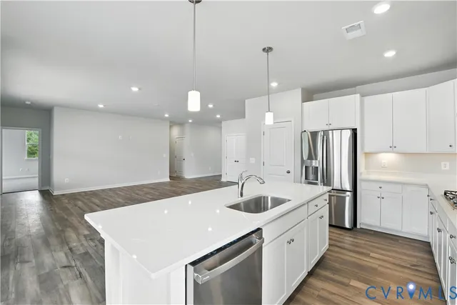 a large kitchen with kitchen island a sink stainless steel appliances and cabinets