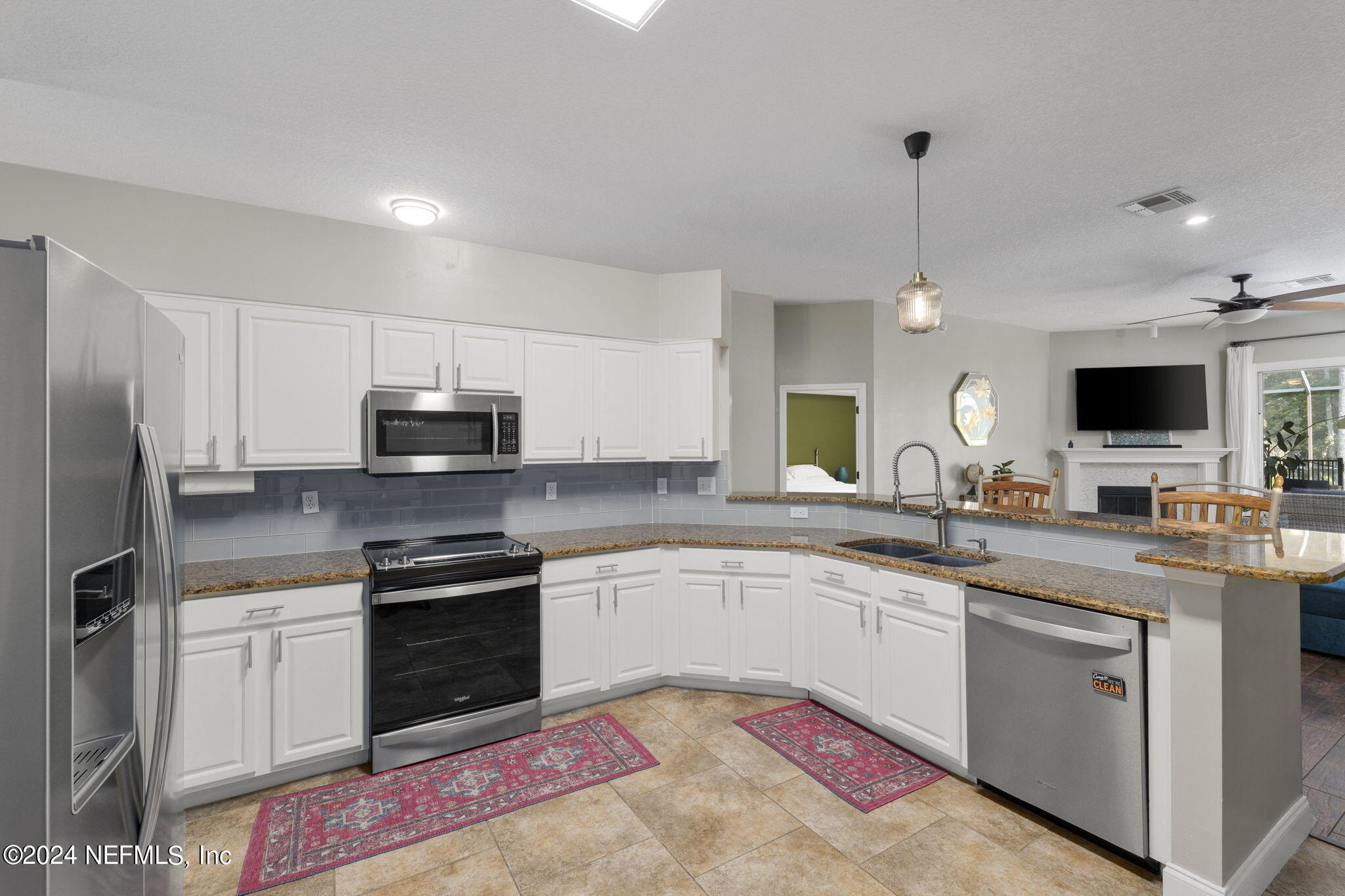1273 Ribbon Road St. Johns, FL 32259 - Photo 27 of 50 a kitchen with stainless steel appliances granite countertop a sink and stove top oven