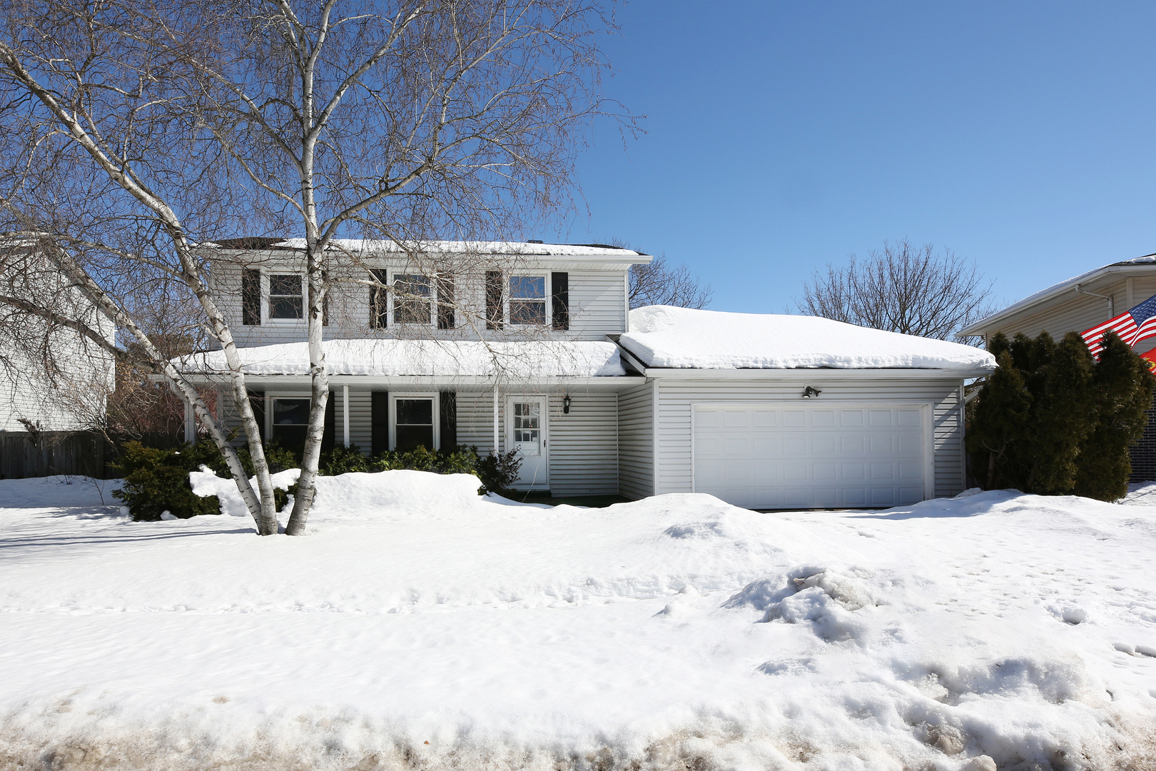 a view of a house with snow in front of house