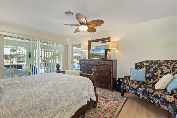 a living room with furniture a chandelier and a dining table