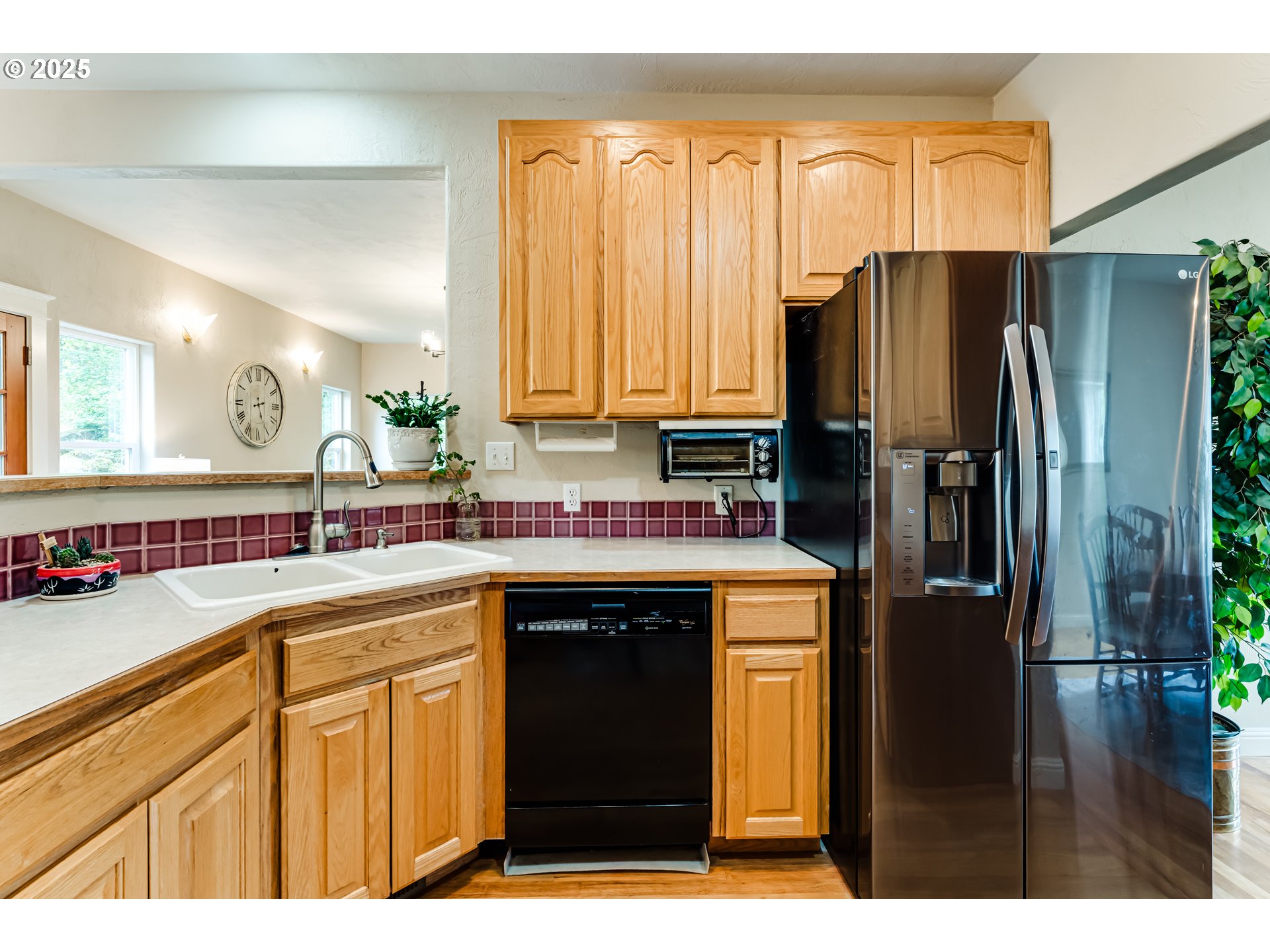 1187 South 69th Street Springfield, OR 97478 - Photo 17 of 42 a kitchen with a sink a refrigerator and cabinets