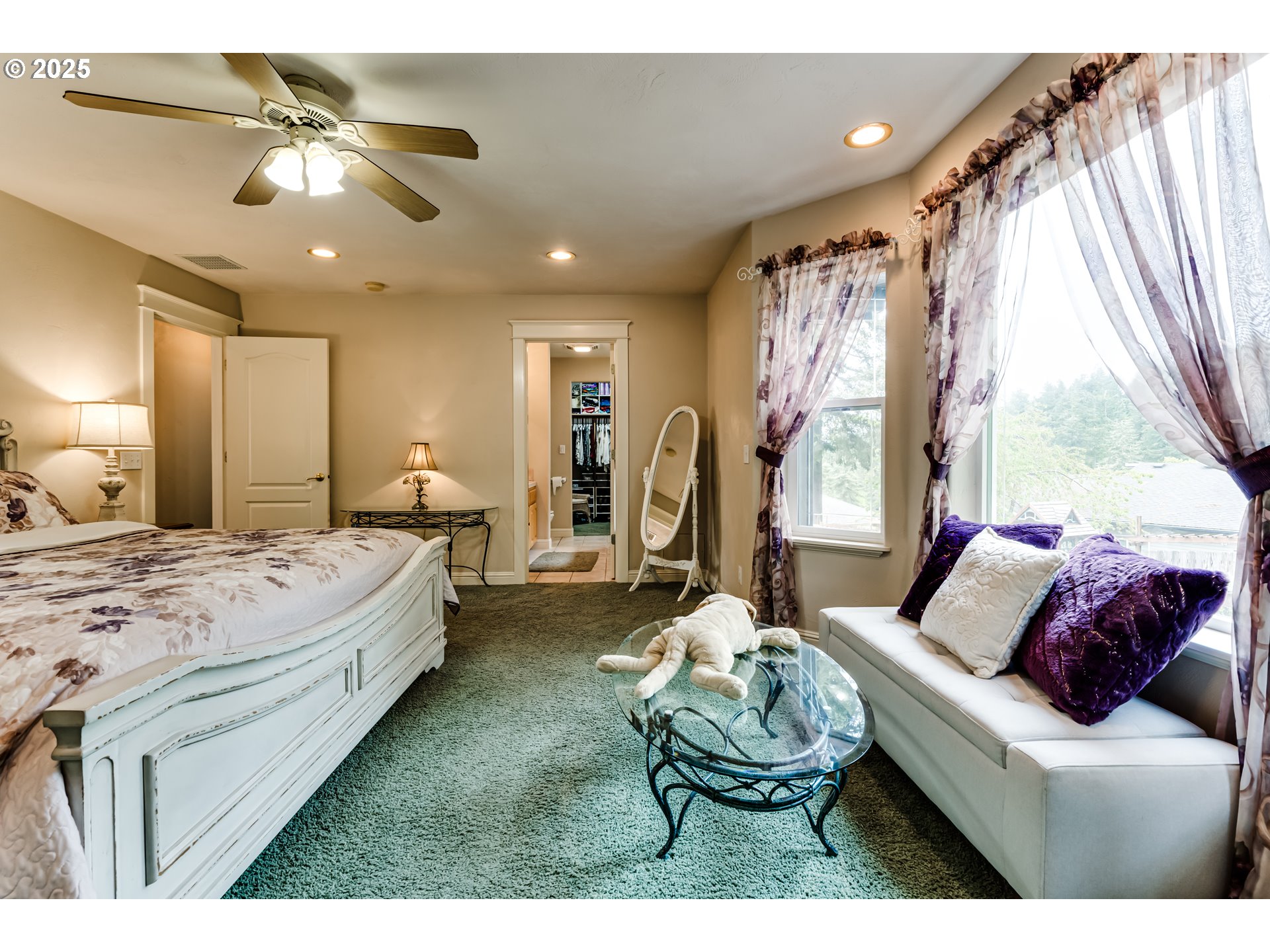 1187 South 69th Street Springfield, OR 97478 - Photo 25 of 42 a spacious bedroom with a bed and a chandelier