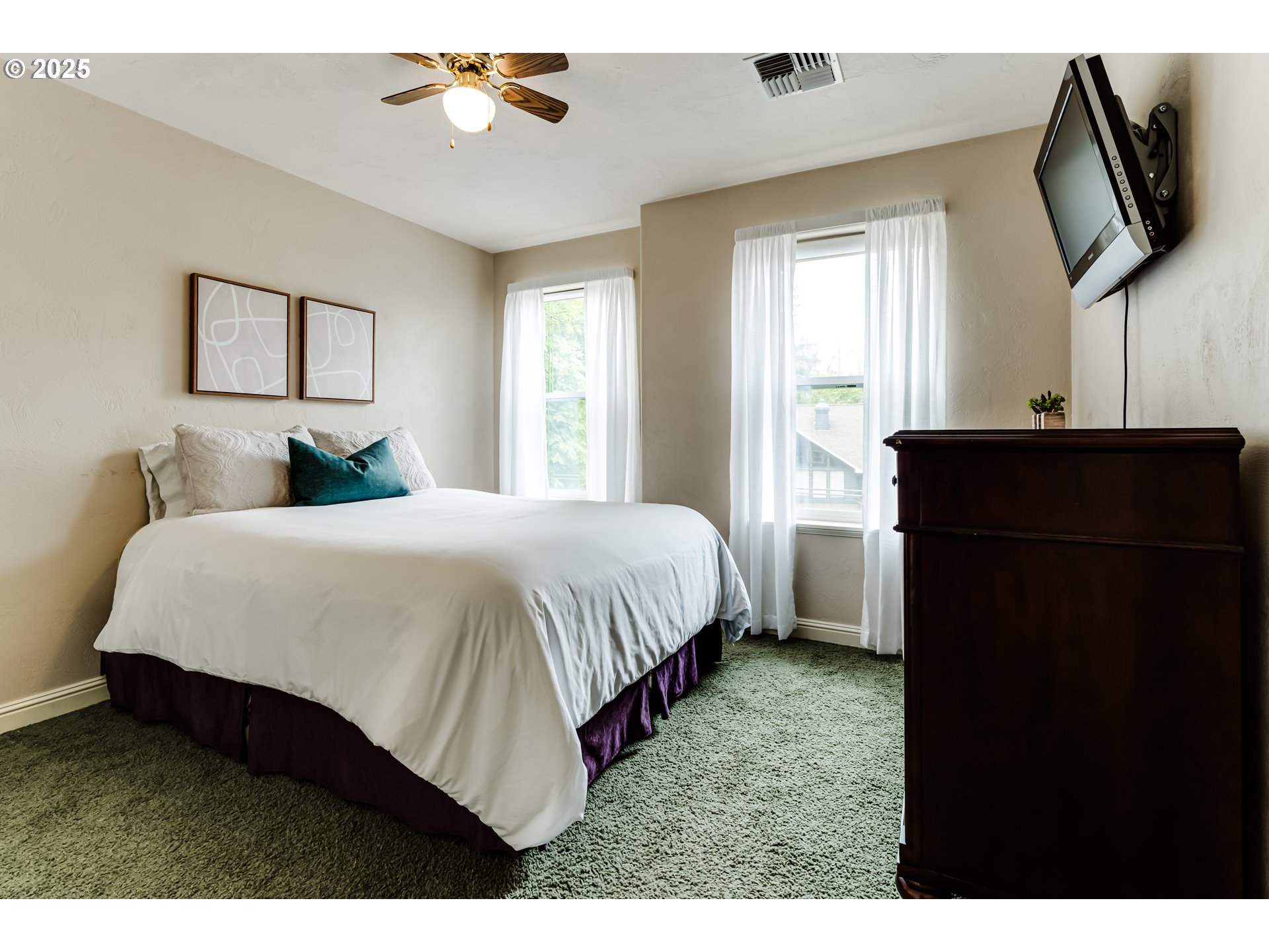 1187 South 69th Street Springfield, OR 97478 - Photo 32 of 42 a bedroom with a bed and a flat tv screen on dresser
