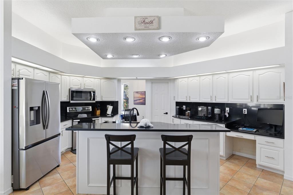 8451 Delta Court Weeki Wachee, FL 34613 - Photo 15 of 64 a kitchen with stainless steel appliances a refrigerator and microwave