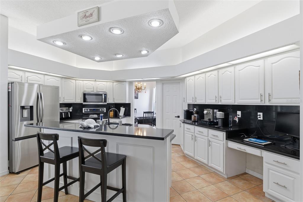 8451 Delta Court Weeki Wachee, FL 34613 - Photo 18 of 64 a kitchen with stainless steel appliances kitchen island granite countertop a sink and cabinets