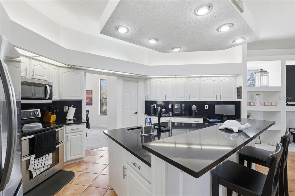 8451 Delta Court Weeki Wachee, FL 34613 - Photo 20 of 64 a kitchen with a table chairs and microwave