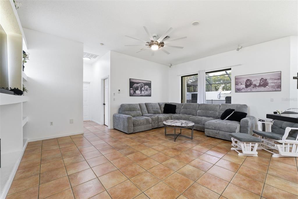8451 Delta Court Weeki Wachee, FL 34613 - Photo 24 of 64 a living room with furniture and a flat screen tv