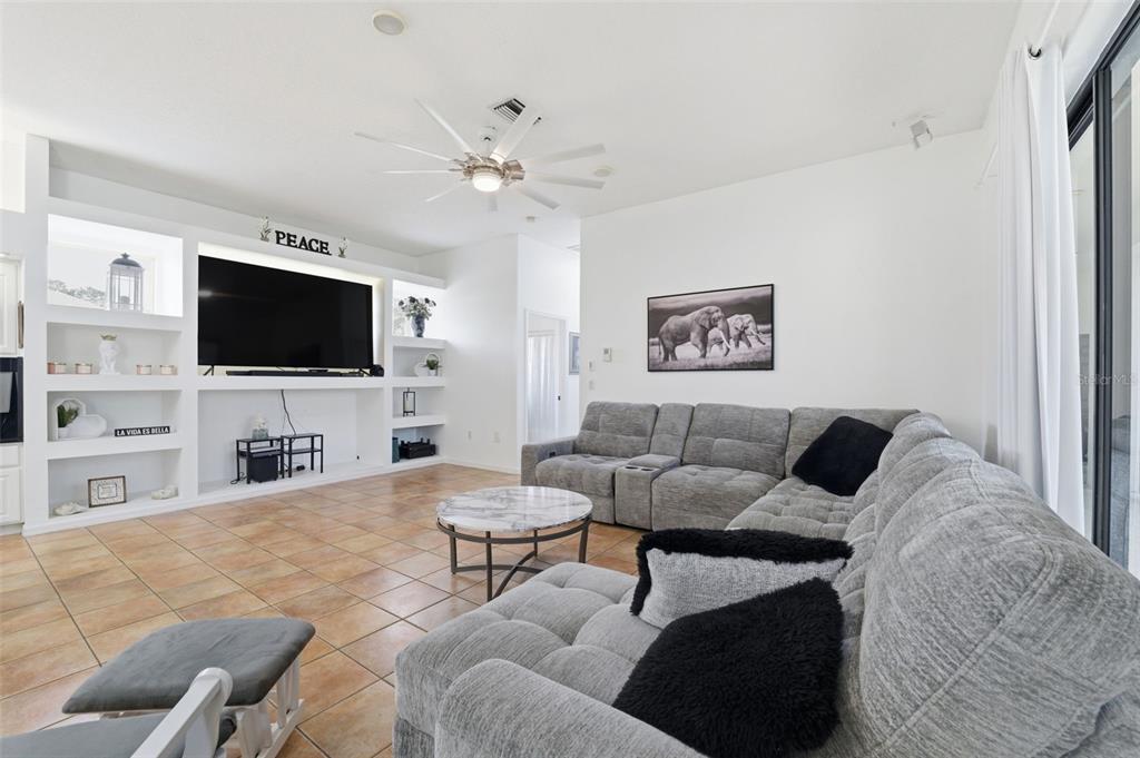 8451 Delta Court Weeki Wachee, FL 34613 - Photo 25 of 64 a living room with furniture and a flat screen tv