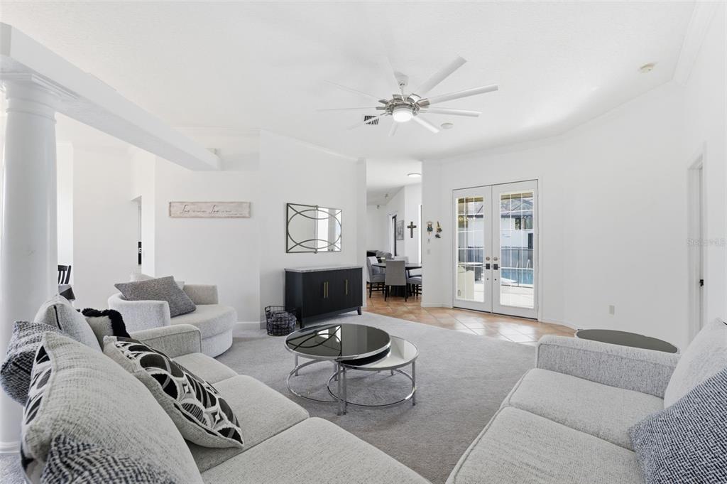8451 Delta Court Weeki Wachee, FL 34613 - Photo 27 of 64 a living room with furniture a rug and a chandelier