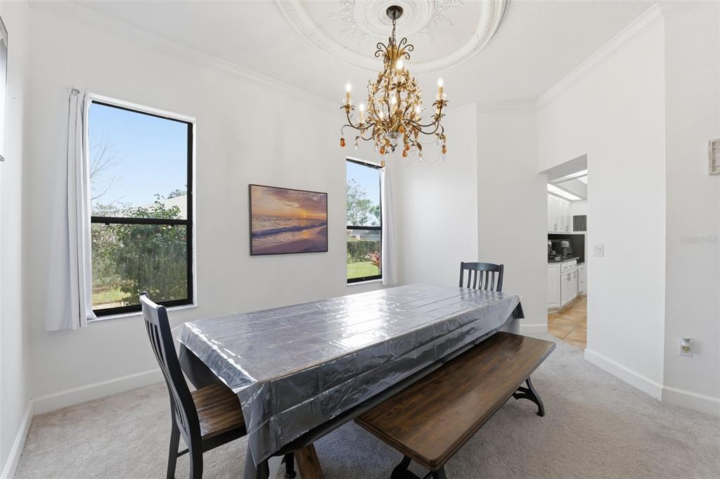 8451 Delta Court Weeki Wachee, FL 34613 - Photo 29 of 64 a view of a dining room with furniture a chandelier and wooden floor