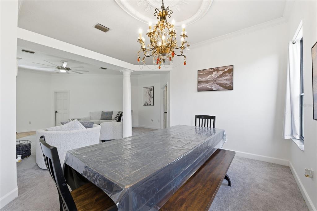 8451 Delta Court Weeki Wachee, FL 34613 - Photo 30 of 64 a dining room with a table and chairs
