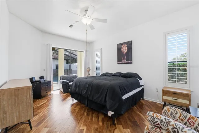 a spacious bedroom with a bed and a chandelier
