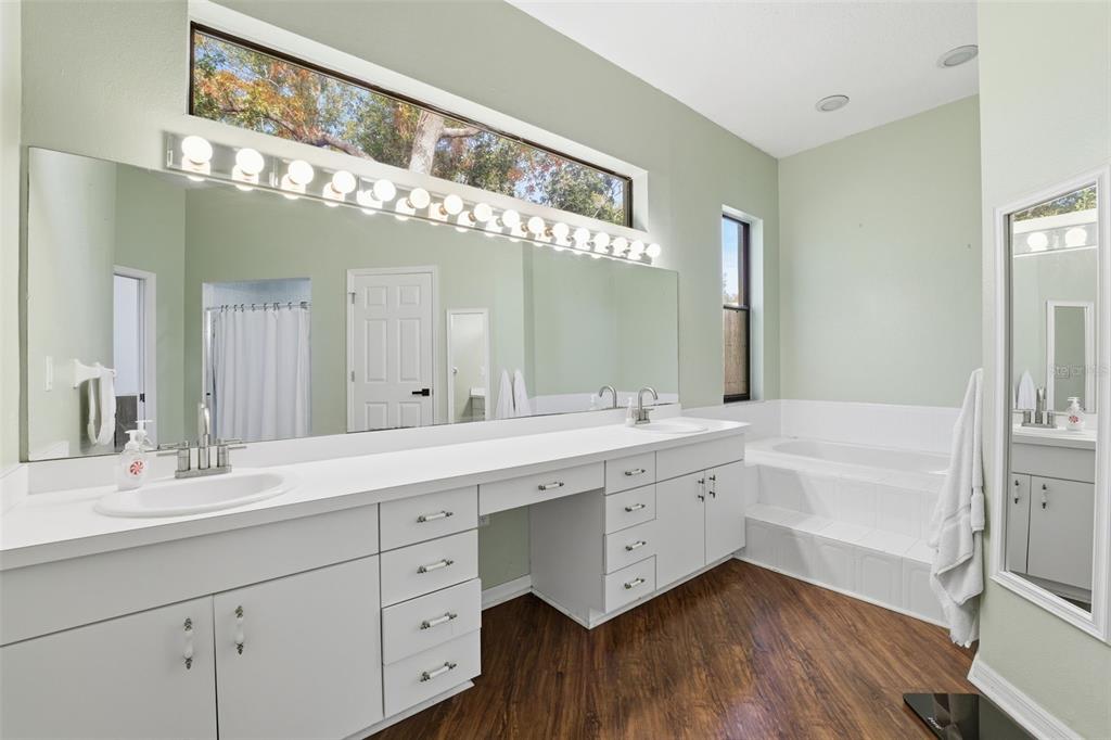 8451 Delta Court Weeki Wachee, FL 34613 - Photo 34 of 64 a spacious bathroom with a double vanity sink a mirror and a bathtub