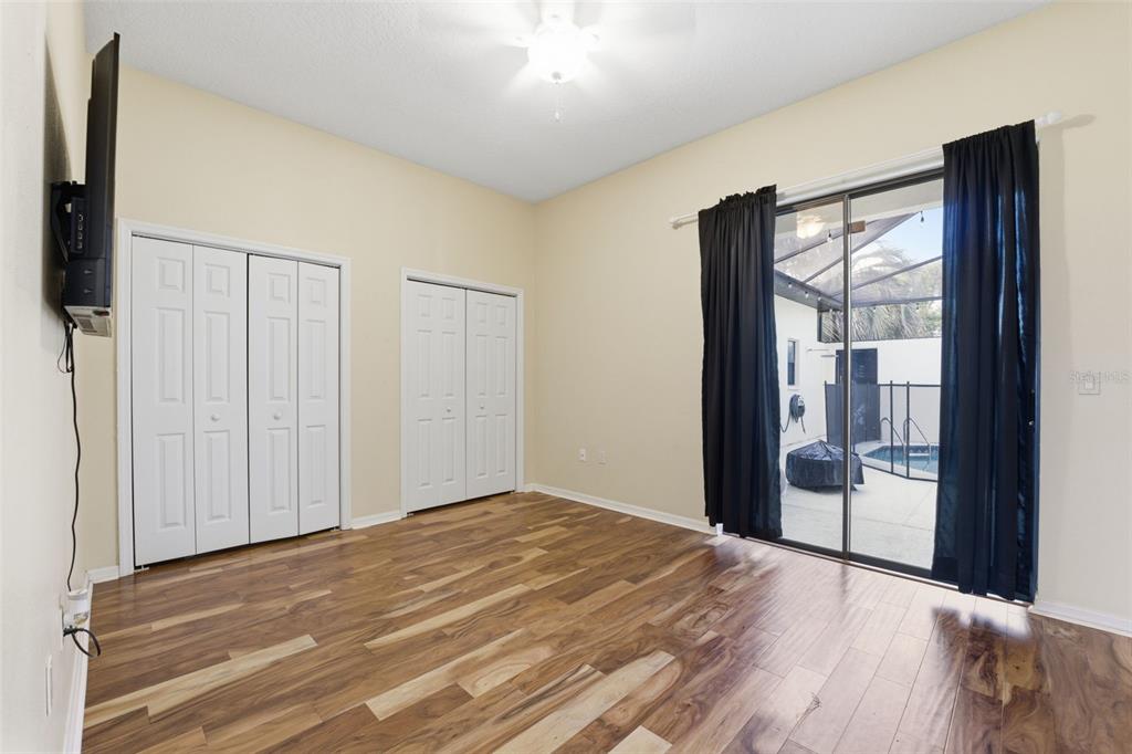 8451 Delta Court Weeki Wachee, FL 34613 - Photo 37 of 64 a view of empty room with wooden floor and fan