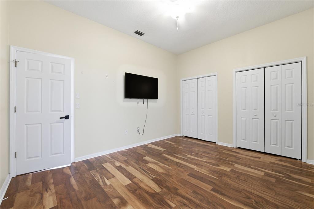 8451 Delta Court Weeki Wachee, FL 34613 - Photo 38 of 64 a view of a livingroom with wooden floor and a flat screen tv