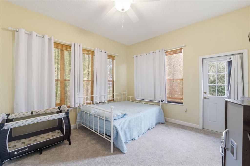 8451 Delta Court Weeki Wachee, FL 34613 - Photo 40 of 64 a spacious bedroom with a bed and a window