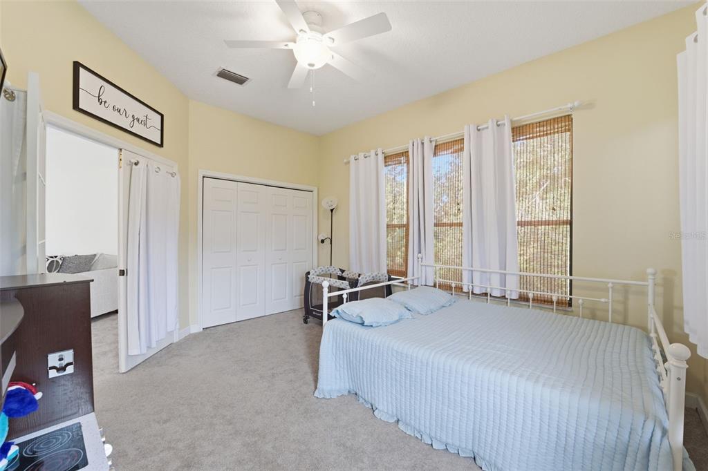 8451 Delta Court Weeki Wachee, FL 34613 - Photo 41 of 64 a spacious bedroom with a bed and a chandelier