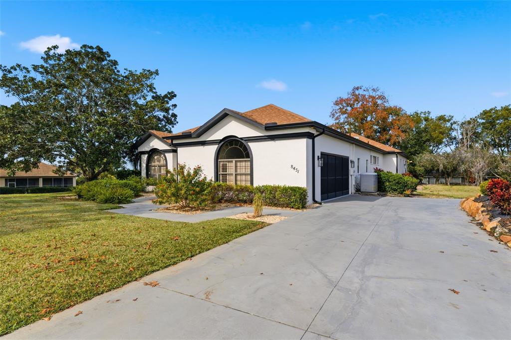 8451 Delta Court Weeki Wachee, FL 34613 - Photo 53 of 64 a front view of a house with a yard and garage