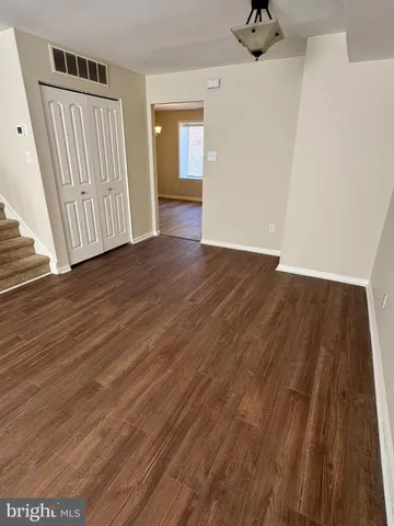 a view of a room with wooden floor and stairs