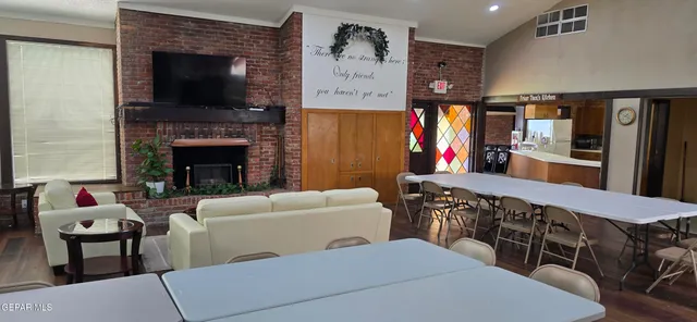 a living room with furniture a flat screen tv and a fireplace